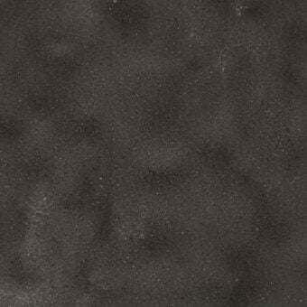 Dark gray concrete texture with mottled pattern, light gray speckles, matte finish, and granular surface suggesting polished stone.
